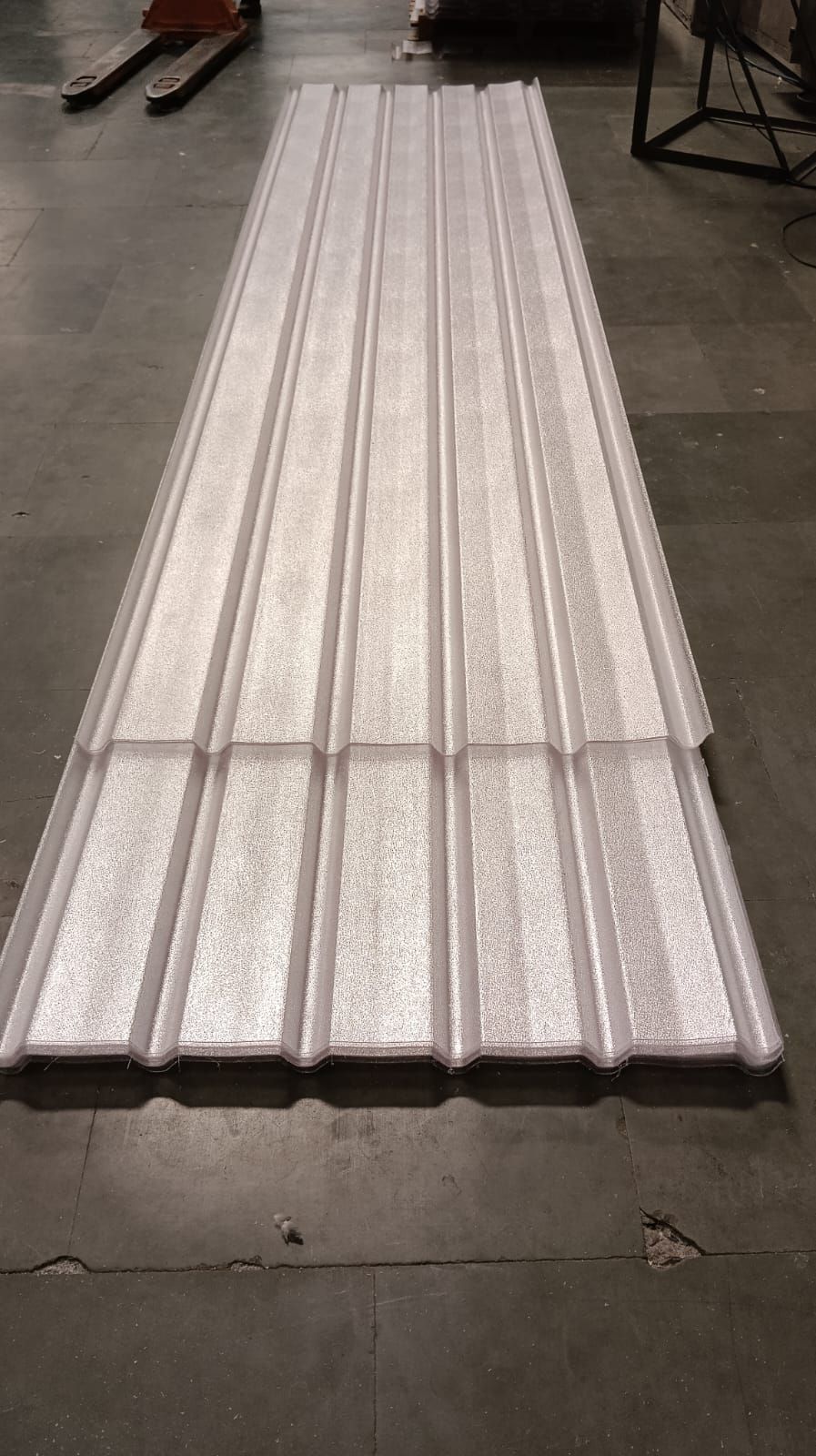 Stack of freshly profiled roofing sheets on the factory floor