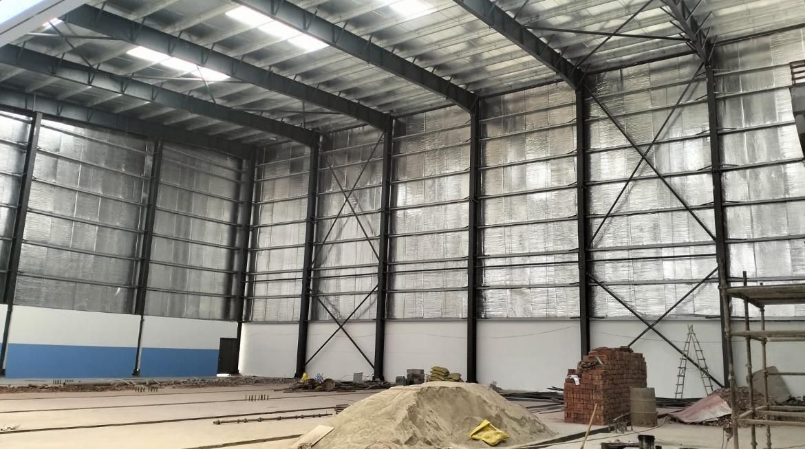 Steel structure building under erection with insulated roofing panels