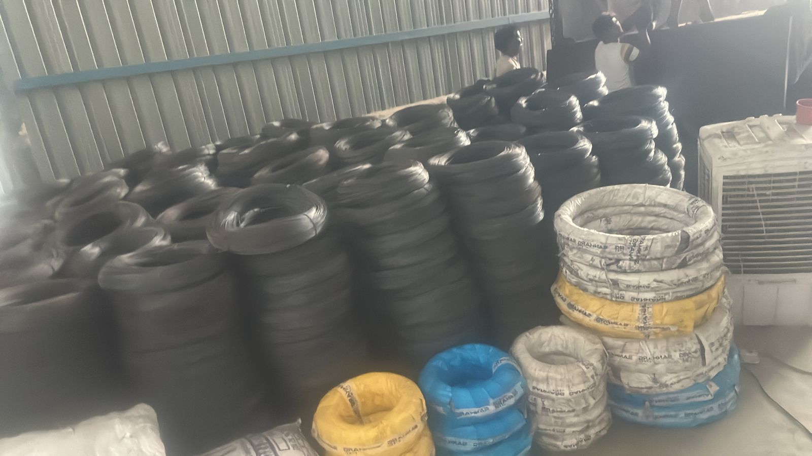 Coiled raw material rolls stored on factory racking