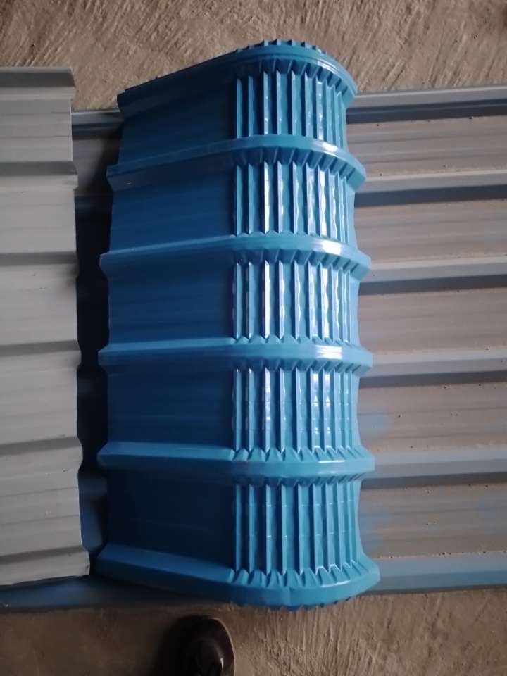 Blue ridge accessory piece fitted on a grey roofing sheet
